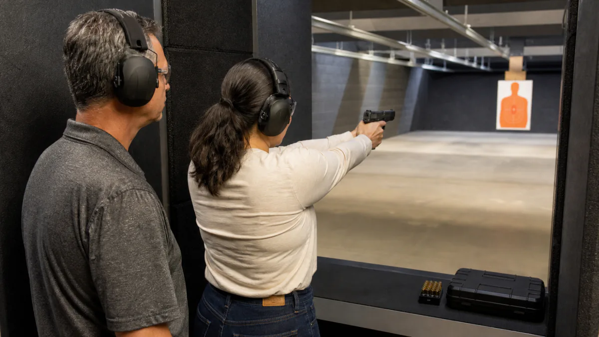 First-time CPL student practicing safely with direct instructor supervision at an indoor range near Detroit